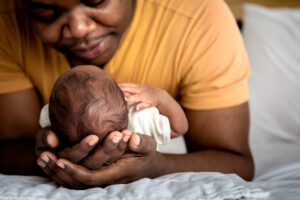 father bonding with newborn